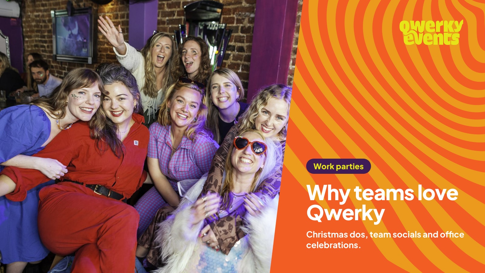 A group of colleagues in matching purple and red outfits squeezing in for a photo at a Qwerky brunch
